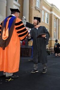 BGSU MBA graduate Raymond Somich shakes hand with dean